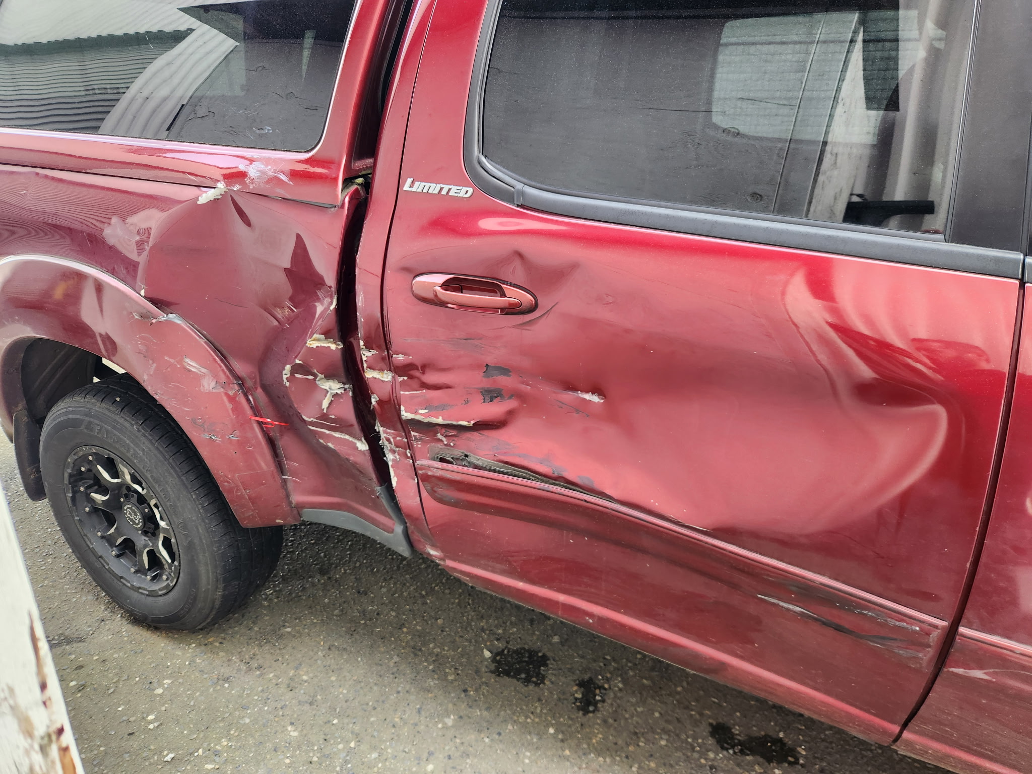 Before repair - red pickup side impact damage